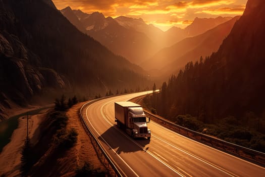 A red semi truck is driving down a mountain road at sunset. The road is narrow and winding, with a beautiful view of the mountains in the background. The sky is filled with orange and pink hues