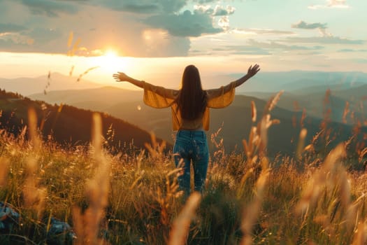 Freedom and serenity woman embracing nature on hilltop at sunset with majestic mountain range in background travel and tranquility concept