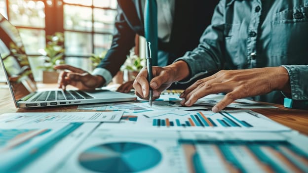 A Business professionals analyzing financial data, pointing at detailed graphs and charts on laptops and documents.