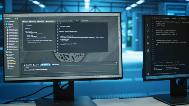 Computers in empty data center facility managing rackmounts energy consumption. Close up of script on PC monitors used for automation and monitoring processes in server room, camera A