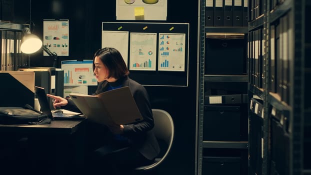 Private agent working in archive room at police to read official records or documents relevant to criminal case investigation. Detective officer conducting background check on suspects. Camera A.