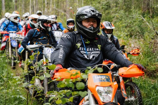 REPUBLIC OF KARELIA, RUSSIA - CIRCA JUNE, 2022: Off-road tournament Ladoga Trophy 2022 in Karelia. Motorcycle racers on sport off-road motorcycles before the start of the race