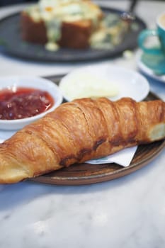 fresh baked croissant on plate with copy space . High quality photo