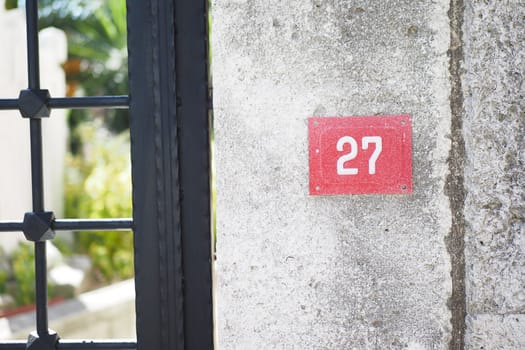 house number. Decorative lettering on a brick wall