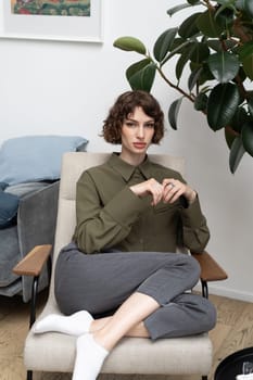 young beautiful woman posing in a green shirt in the studio