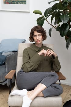 young beautiful woman posing in a green shirt in the studio