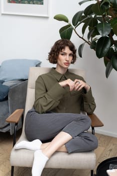 young beautiful woman posing in a green shirt in the studio