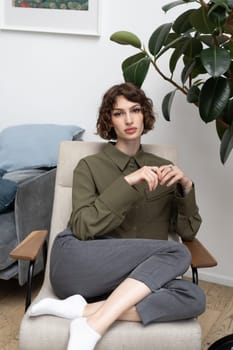 young beautiful woman posing in a green shirt in the studio