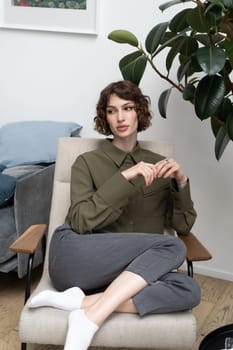 young beautiful woman posing in a green shirt in the studio