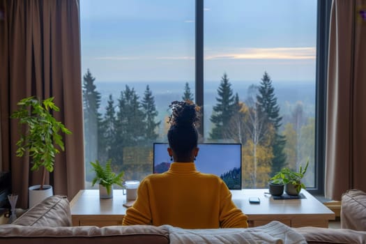 American African woman working with laptop at luxury home.