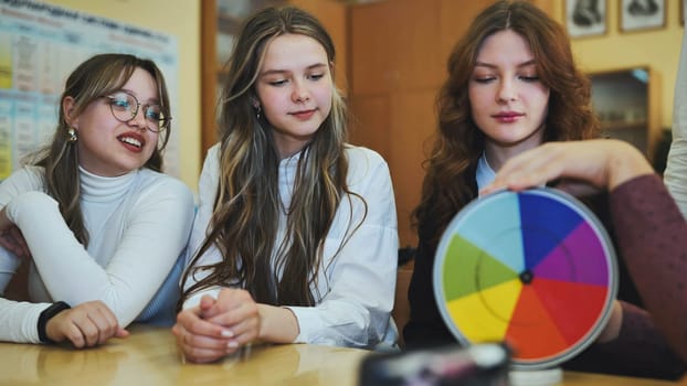 Students in physics class spin Newton's multicolored disk