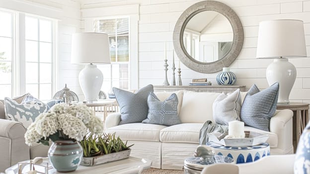 Interior of a living room with white walls, sofa and cushions. Sitting room in coastal cottage with sea view. Luxury lounge room