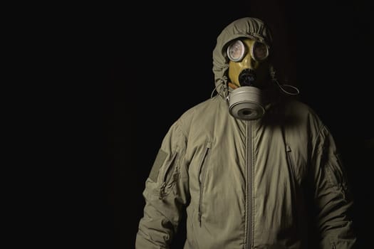 man in a gas mask protects himself from coronavirus at night