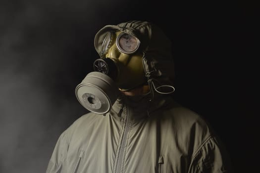 man in a gas mask protects himself from coronavirus at night