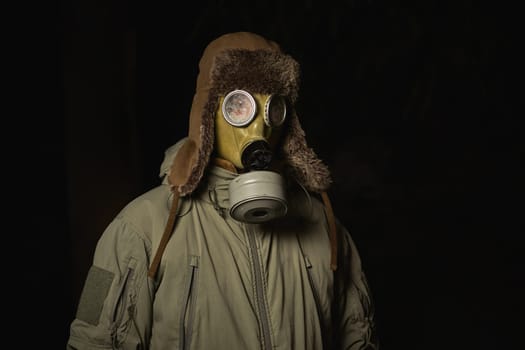 man in a gas mask protects himself from coronavirus at night