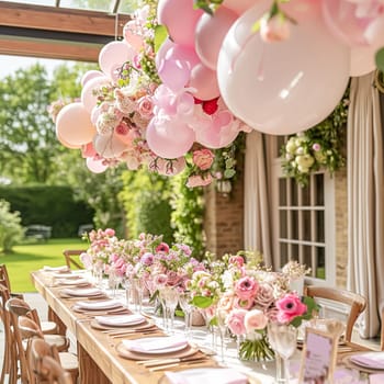 Birthday table decoration with sweets, flowers, candles and pink balloons. Selective focus