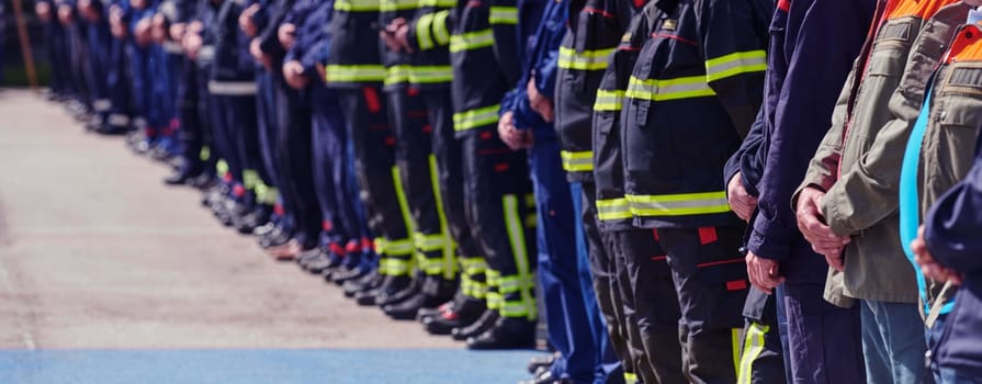 A group of firefighters lined up, saluting the flag, applauding in solidarity, and gearing up for intensive training sessions, showcasing their unwavering commitment to service and teamwork