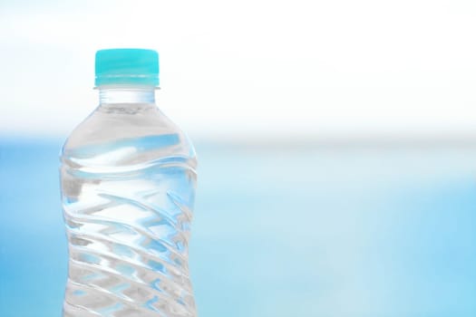 drinks, summertime and environment concept - bottle of water on the beach, elegant visuals