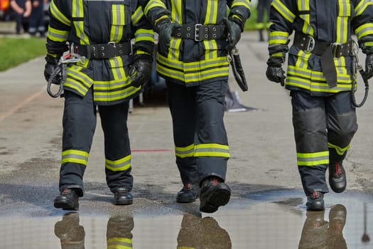 A team of confident and accomplished firefighters strides purposefully in their uniforms, exuding pride and satisfaction after successfully completing a challenging firefighting mission.