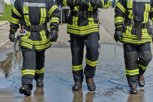 A team of confident and accomplished firefighters strides purposefully in their uniforms, exuding pride and satisfaction after successfully completing a challenging firefighting mission.