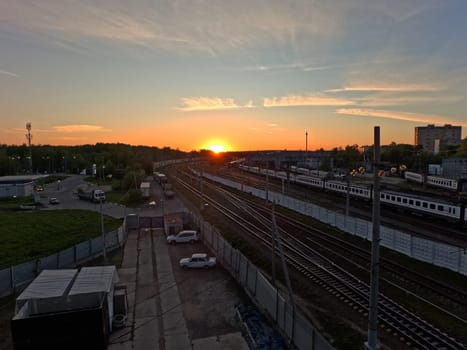 Sunset against the background of railway infrastructure solutions. sunset over the depot. High quality photo