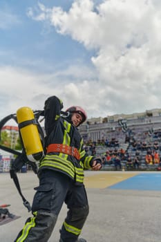 A firefighter dons the essential components of their professional gear, embodying resilience, commitment, and readiness as they gear up for a hazardous firefighting mission, a testament to their unwavering dedication to protecting and saving lives.