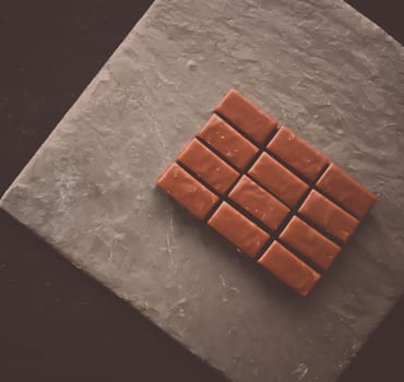 Sweet swiss chocolate candies on a stone tabletop, flatlay - desserts, confectionery and gluten-free organic food concept. All you need is chocolate