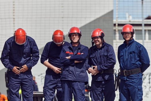 A team of confident and accomplished firefighters strides purposefully in their uniforms, exuding pride and satisfaction after successfully completing a challenging firefighting mission.