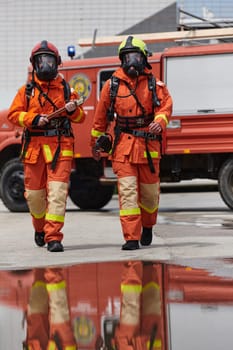 A team of confident and accomplished firefighters strides purposefully in their uniforms, exuding pride and satisfaction after successfully completing a challenging firefighting mission.