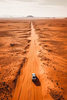 A white car is driving down a dirt road in a desert. The road is narrow and winding, and the landscape is barren and dry. The car is the only object in the scene