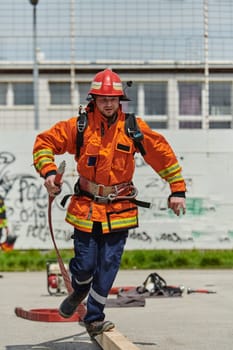 A firefighter, clad in professional gear, undergoes rigorous training to prepare for the hazards awaiting him on duty