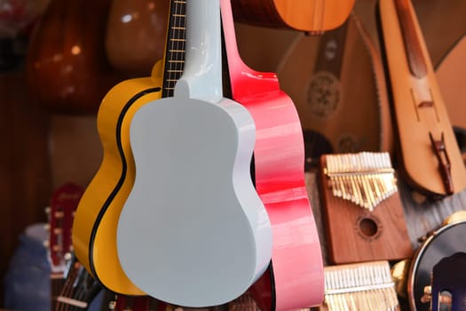 Row of colorful guitars hanging ,