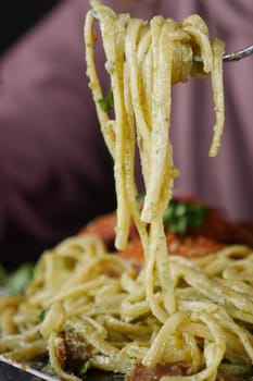 CloseUp of a Fork with Spaghetti in a Charming Italian Restaurant Setting.