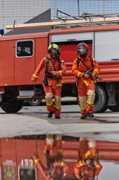 A team of confident and accomplished firefighters strides purposefully in their uniforms, exuding pride and satisfaction after successfully completing a challenging firefighting mission.