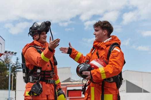 A unified team of firefighters, adorned in their uniforms, engages in a heartfelt celebration marked by triumphant salutes and cheers, embodying the joy and gratitude following the successful completion of a challenging firefighting mission.