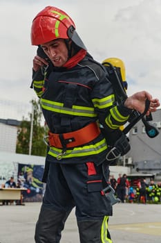 A professional firefighter dons his protective gear, preparing to respond to an emergency call.