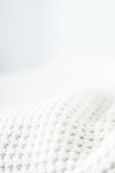 Knitwear, fabric textures and handmade items concept - Warm knitted clothes, soft and white