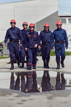 A team of confident and accomplished firefighters strides purposefully in their uniforms, exuding pride and satisfaction after successfully completing a challenging firefighting mission.