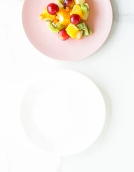 juicy fruit salad for breakfast on marble, flatlay - dieting and healthy lifestyle styled concept