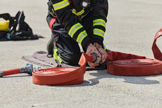 A firefighter dons the essential components of their professional gear, embodying resilience, commitment, and readiness as they gear up for a hazardous firefighting mission, a testament to their unwavering dedication to protecting and saving lives.