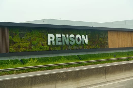 Waregem, Belgium - May 22, 2023: A large building with a green wall and the Renson logo visible, located in Belgium.