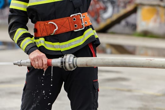 In a dynamic display of synchronized teamwork, firefighters hustle to carry, connect, and deploy firefighting hoses with precision, showcasing their intensive training and readiness for challenging and high-risk situations ahead.