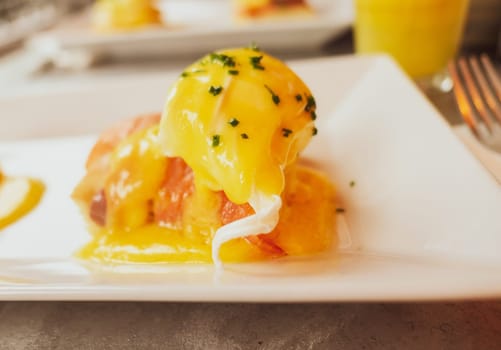 Restaurant service, food recipes and breakfast concept - Poached egg with salmon for brunch in a luxury restaurant