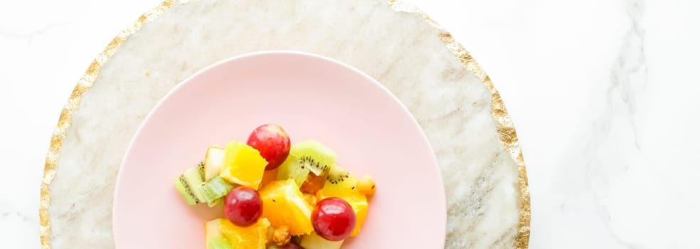 juicy fruit salad for breakfast on marble, flatlay - dieting and healthy lifestyle styled concept