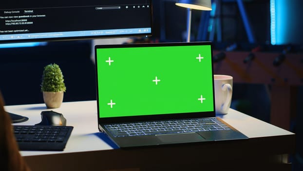 Green screen laptop in home office used for developing software applications. Mockup notebook used by teleworking IT specialist for programming, camera A close up panning shot