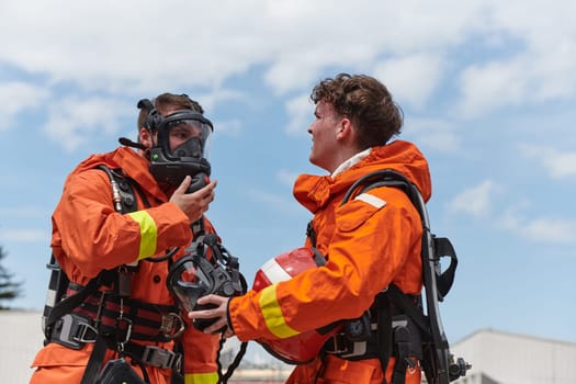 A unified team of firefighters, adorned in their uniforms, engages in a heartfelt celebration marked by triumphant salutes and cheers, embodying the joy and gratitude following the successful completion of a challenging firefighting mission.