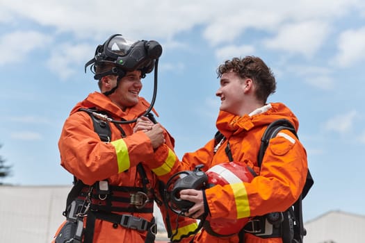 A unified team of firefighters, adorned in their uniforms, engages in a heartfelt celebration marked by triumphant salutes and cheers, embodying the joy and gratitude following the successful completion of a challenging firefighting mission.