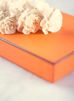 Present box and flowers for her - Mother's day ideas, happy giving and holiday inspiration concept. The perfect gift for mom