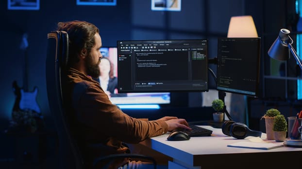 Experienced programmer writing code on computer screen while in office using java programming languages. Developer working on fixing database errors while working from home, camera A