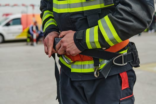 A professional firefighter dons his protective gear, preparing to respond to an emergency call.